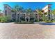 Elegant condo building with palm trees and a paved courtyard at 87 Vivante Blvd # 403, Punta Gorda, FL 33950