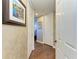Bright hallway with hardwood floors and neutral walls at 87 Vivante Blvd # 403, Punta Gorda, FL 33950