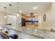 Granite kitchen island with breakfast bar and stainless steel appliances at 87 Vivante Blvd # 403, Punta Gorda, FL 33950