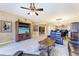 Open living area with hardwood floors, leather furniture, and kitchen access at 87 Vivante Blvd # 403, Punta Gorda, FL 33950