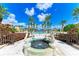 Resort-style pool with fountain, lush landscaping, and palm trees at 87 Vivante Blvd # 403, Punta Gorda, FL 33950