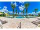 Freeform pool with lounge chairs and palm trees at 87 Vivante Blvd # 403, Punta Gorda, FL 33950