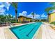 Resort-style lap pool with lounge chairs at 87 Vivante Blvd # 403, Punta Gorda, FL 33950