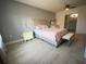 Bedroom with a light pink bedspread and light flooring at 8818 Ashman Rd, Riverview, FL 33578