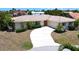 Single-story home with tile roof, driveway, and mature landscaping at 951 Santa Brigida Ct, Punta Gorda, FL 33950