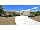 Single-story home exterior with landscaping, driveway, and attached garage at 951 Santa Brigida Ct, Punta Gorda, FL 33950