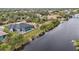 Aerial view showcasing a waterfront property with a pool at 9516 President Cir, Port Charlotte, FL 33981