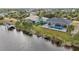 Aerial view of a canal-front home with a pool and dock at 9516 President Cir, Port Charlotte, FL 33981