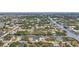 Aerial view of a waterfront home and surrounding neighborhood at 9516 President Cir, Port Charlotte, FL 33981