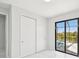 Bedroom with sliding glass doors, pool access, and large closet at 9516 President Cir, Port Charlotte, FL 33981