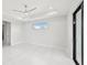 Spacious bedroom with ceiling fan and sliding door at 9516 President Cir, Port Charlotte, FL 33981