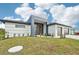 Modern home with a two-car garage and spacious front yard at 9516 President Cir, Port Charlotte, FL 33981