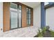 Modern front entrance with wood paneling and glass double doors at 9516 President Cir, Port Charlotte, FL 33981