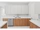 Modern kitchen with wood cabinets and stainless steel dishwasher at 9516 President Cir, Port Charlotte, FL 33981