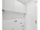 Laundry room with overhead cabinets and utility hookups at 9516 President Cir, Port Charlotte, FL 33981