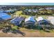 Aerial view of three homes with private pools and lush landscaping at 10 Windward Ct, Placida, FL 33946