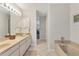 Bathroom with double sinks, a bathtub, and tiled floors at 10 Windward Ct, Placida, FL 33946