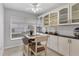 Bright eat-in kitchen with white cabinets and granite countertops at 10 Windward Ct, Placida, FL 33946