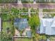 Aerial view of a house nestled in a neighborhood with tropical landscaping at 110 Chasteen St, Punta Gorda, FL 33950