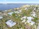 Aerial view of a neighborhood near the water, showing houses and palm trees at 110 Chasteen St, Punta Gorda, FL 33950