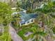 Aerial view of a single-Gathering home with a green roof and palm trees at 110 Chasteen St, Punta Gorda, FL 33950