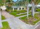 Single story home with green roof and palm trees at 110 Chasteen St, Punta Gorda, FL 33950