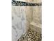 Shower with marble tile and pebble floor at 1188 Paraclete Rd, Punta Gorda, FL 33983