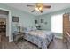 Charming bedroom with a queen bed, ceiling fan, and built-in shelving at 1188 Paraclete Rd, Punta Gorda, FL 33983