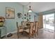 Bright dining room with glass table and wooden chairs, leading to a view of the backyard at 1188 Paraclete Rd, Punta Gorda, FL 33983