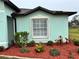 Light teal house exterior with manicured landscaping and red mulch at 1188 Paraclete Rd, Punta Gorda, FL 33983