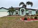 Light teal single-story house with a two-car garage at 1188 Paraclete Rd, Punta Gorda, FL 33983