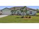 Light teal house with a two-car garage and manicured landscaping at 1188 Paraclete Rd, Punta Gorda, FL 33983