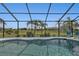 Relaxing pool area with a screened enclosure and backyard view at 1188 Paraclete Rd, Punta Gorda, FL 33983