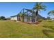 Screened pool enclosure with lush landscaping and a grassy yard at 1188 Paraclete Rd, Punta Gorda, FL 33983