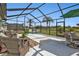 Spacious screened patio with seating area and lush landscaping at 1188 Paraclete Rd, Punta Gorda, FL 33983