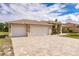 Two-car garage with a paver driveway at 13039 Ridgely Cir, Port Charlotte, FL 33981