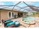 Relaxing pool and spa area with covered patio and outdoor kitchen at 13039 Ridgely Cir, Port Charlotte, FL 33981