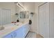 Double vanity bathroom with white cabinets and large mirror at 1347 Hedgewood Cir, North Port, FL 34288