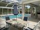 Relaxing community pool with screened patio and seating area at 1347 Hedgewood Cir, North Port, FL 34288