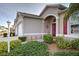 House exterior showcasing landscaping and walkway to entrance at 1347 Hedgewood Cir, North Port, FL 34288