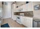 Modern kitchen featuring white cabinets and tile backsplash at 1347 Hedgewood Cir, North Port, FL 34288