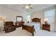 Spacious main bedroom with wooden furniture and access to patio at 1347 Hedgewood Cir, North Port, FL 34288