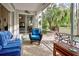 Relaxing screened patio with seating area overlooking a lush backyard at 1347 Hedgewood Cir, North Port, FL 34288