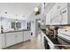 White kitchen with granite counters, stainless steel appliances, and breakfast bar at 14057 Maxwell Ave, Port Charlotte, FL 33953