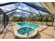 Inviting screened-in pool and spa with ample lounging space at 14057 Maxwell Ave, Port Charlotte, FL 33953