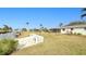 Landscaped backyard with canal view and seating area at 148 Salem Nw Ave, Port Charlotte, FL 33952