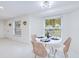 Bright dining area with white table and chairs, natural light, and terrazzo flooring at 148 Salem Nw Ave, Port Charlotte, FL 33952