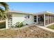 Side view of house, showcasing landscaping and screened porch at 148 Salem Nw Ave, Port Charlotte, FL 33952