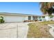 Front view of house with driveway and landscaping at 148 Salem Nw Ave, Port Charlotte, FL 33952