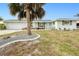 Front view of house with palm tree and gravel landscaping at 148 Salem Nw Ave, Port Charlotte, FL 33952